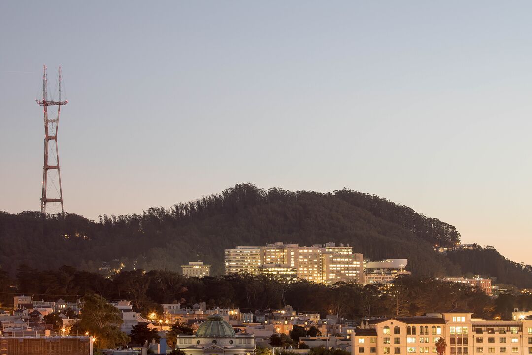 Dusk view of Parnassus heights campus, with Mt Sutro and the Sutro Tower in the background