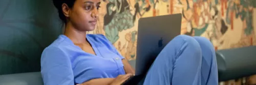 Young person intently focused on a laptop screen