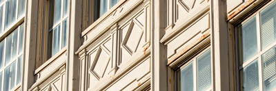 Afternoon light on a detailed view of a neoclassical building facade